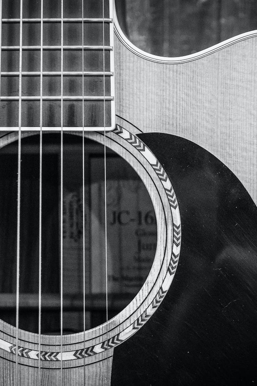 grayscale_photo_of_cutaway_acoustic_guitar
