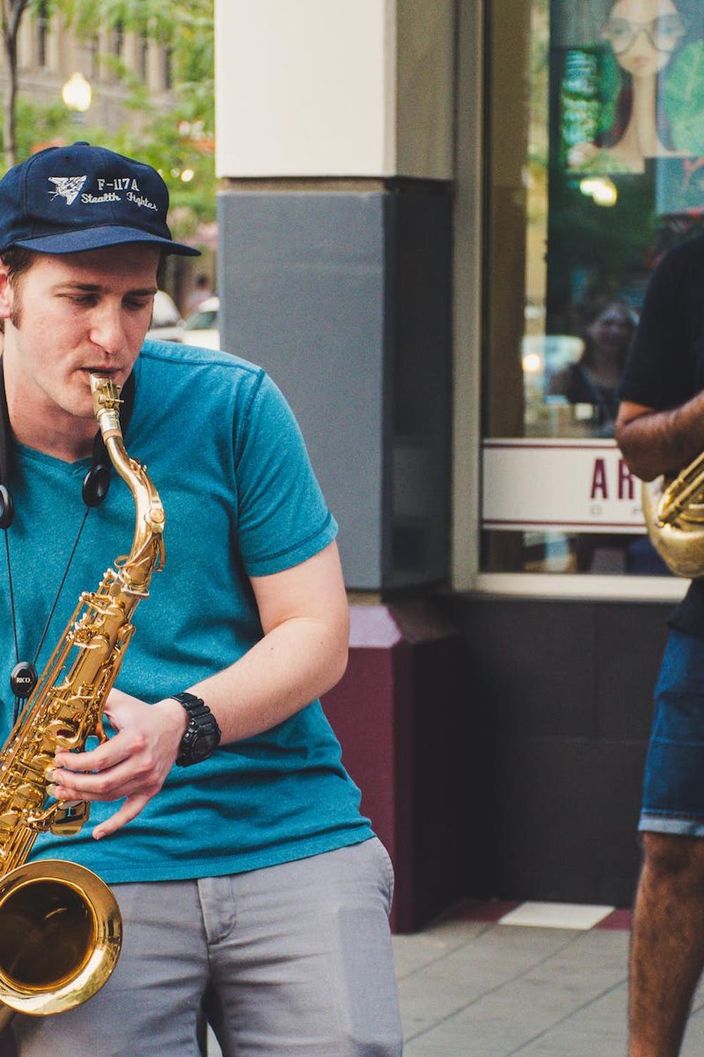 two_men_blowing_air_instruments